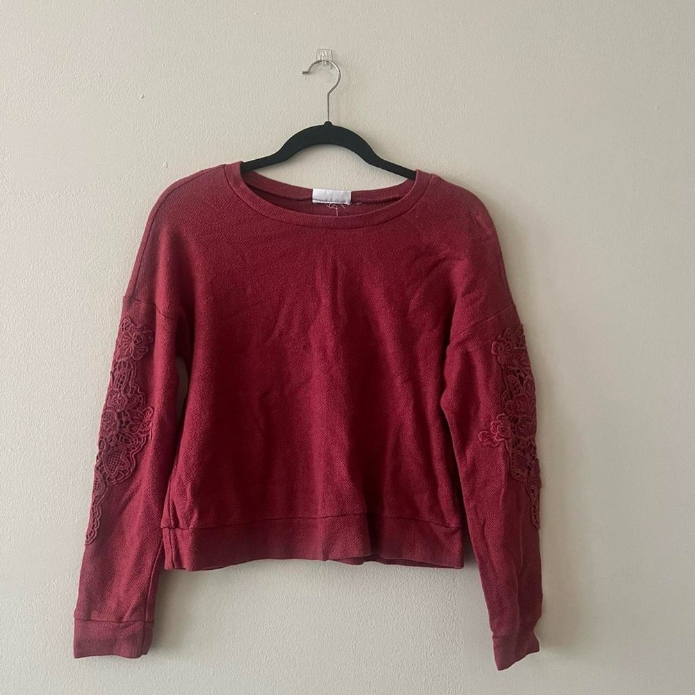 cozy crimson sweater with lace appliqué at the elbow